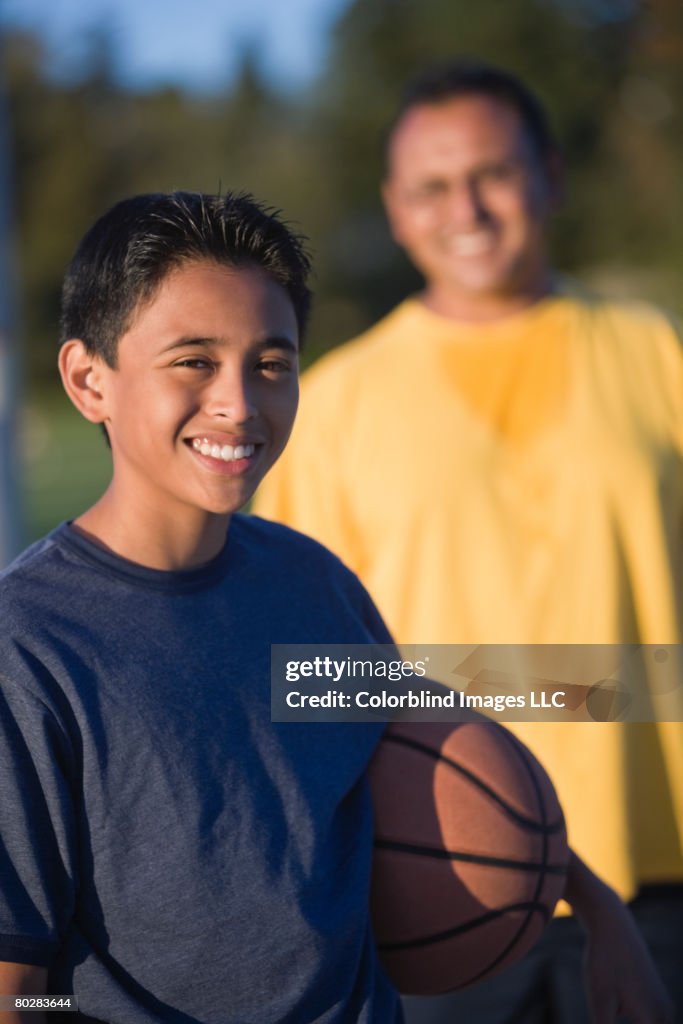 Hispanic boy holding basketball