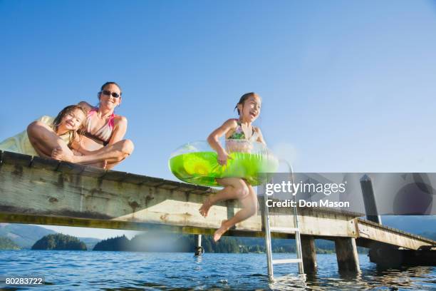 asian girl jumping in lake - tube girl fotografías e imágenes de stock