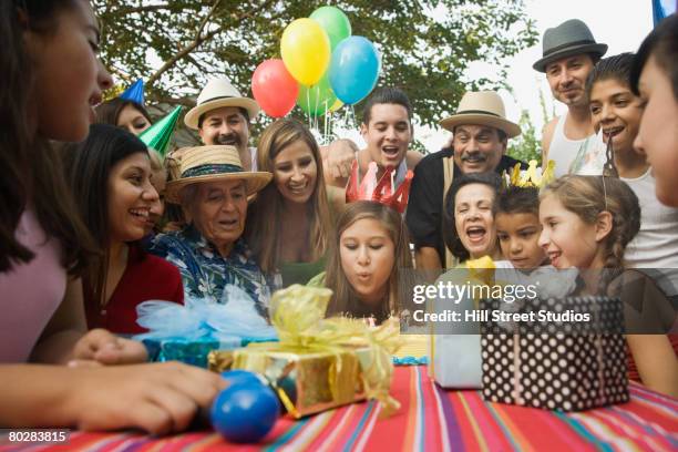 hispanic girl celebrating birthday with family - 80 jahre torte stock-fotos und bilder