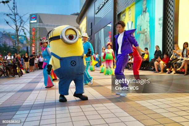 Minions dances with people at Wangfujing Street on June 20, 2017 in Beijing, China. The Minions joined in a square dancing team in the evening on...