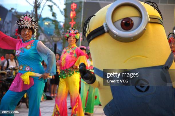 Minions dances with people at Wangfujing Street on June 20, 2017 in Beijing, China. The Minions joined in a square dancing team in the evening on...