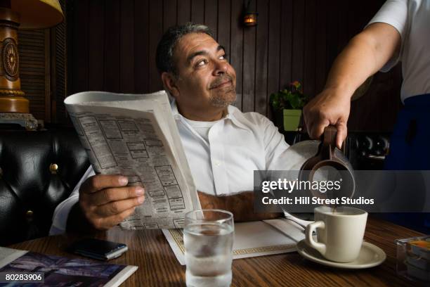 hispanic man getting coffee at diner - ordering coffee stock pictures, royalty-free photos & images