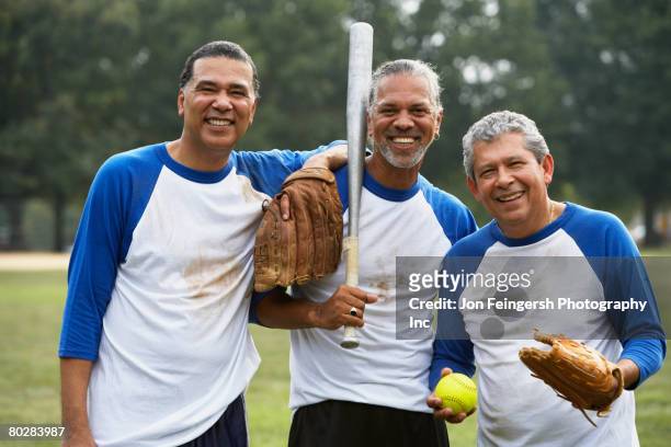 multi-ethnic men with baseball gear - baseballmannschaft stock-fotos und bilder