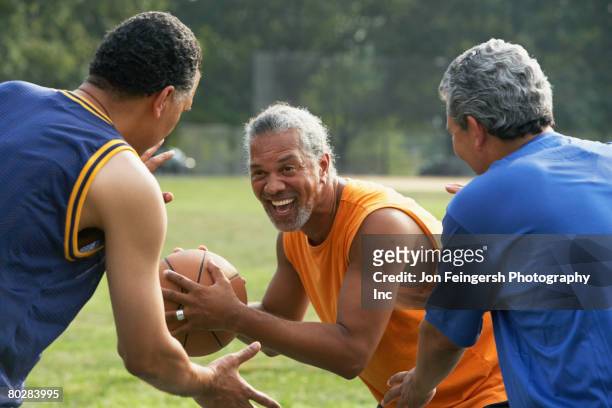 multi-ethnic men playing basketball - blocking sports activity stock pictures, royalty-free photos & images