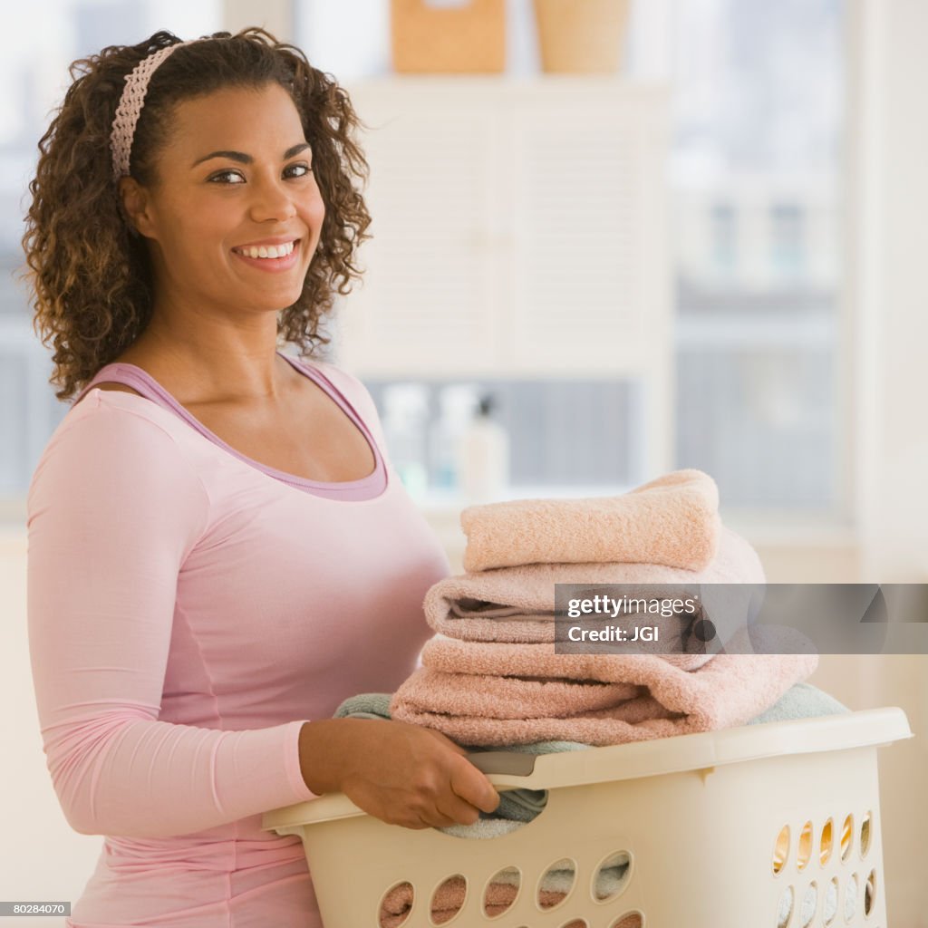 African woman carrying laundry basket