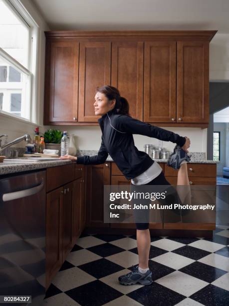 pacific islander woman stretching - warm up exercise indoor stock pictures, royalty-free photos & images