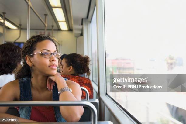 african woman riding on train - 20 29 years stock pictures, royalty-free photos & images