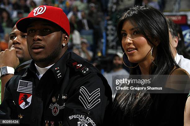 New Orleans Saints running back Reggie Bush sits with Kim Kardashian during the New Orleans Hornets and Chicago Bulls game on March 17, 2008 at the...