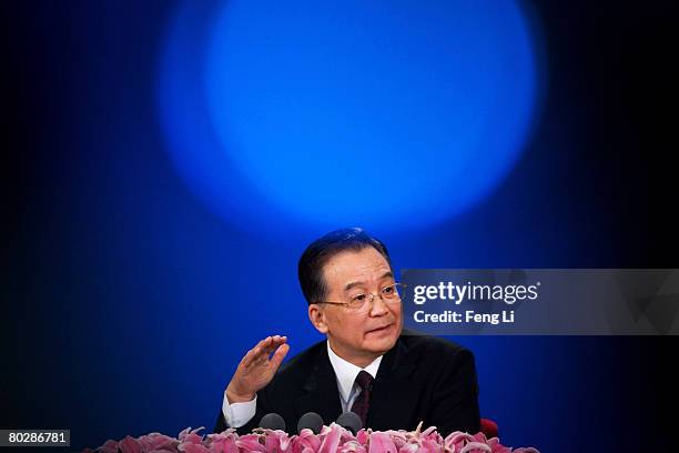 Chinese Premier Wen Jiabao gestures during a news conference at the end of the annual session of the National People's Congress, or parliament, at...