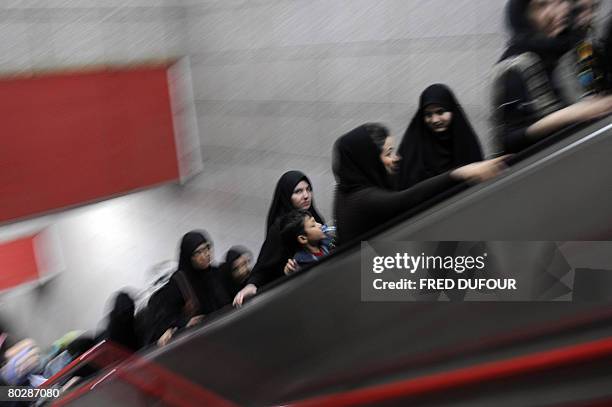 Iranian women go up an electric staircase after getting off the subway in Tehran on March 17 a few days before the Persian new year or Noruz which...