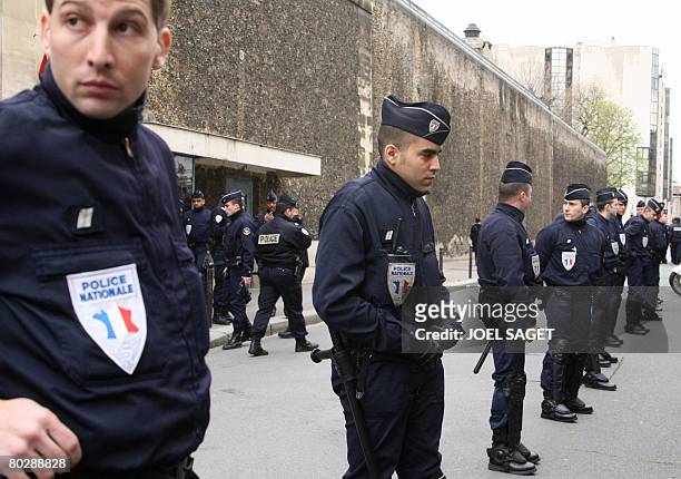 Policemen stand in front of La Sante prison before Jerome Kerviel left it, on March 18 2008 in Paris, as a Paris court ordered today the release of...