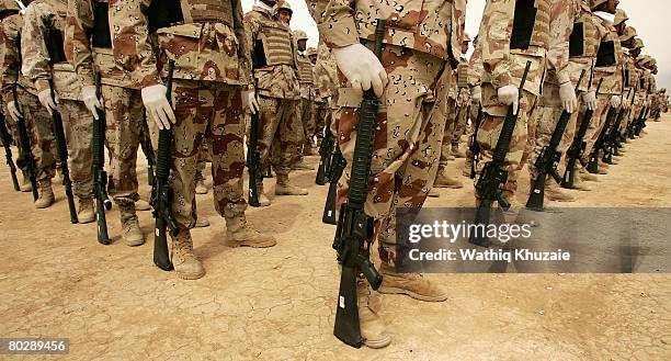 Iraqi army soldiers from the 4th Brigade of the 5th Division stand in ranks during their graduation ceremony at Besmaya Range Complex on March 18...