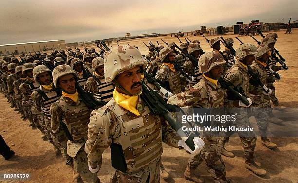 Iraqi army soldiers from the 4th Brigade of the 5th Division march in ranks during their graduation ceremony at Besmaya Range Complex on March 18...