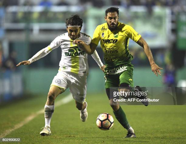 Brazil's Chapecoense defender Apodi vies for the ball with with Argentina's Defensa y Justicia midfielder Jonas Gutierrez during their Copa...