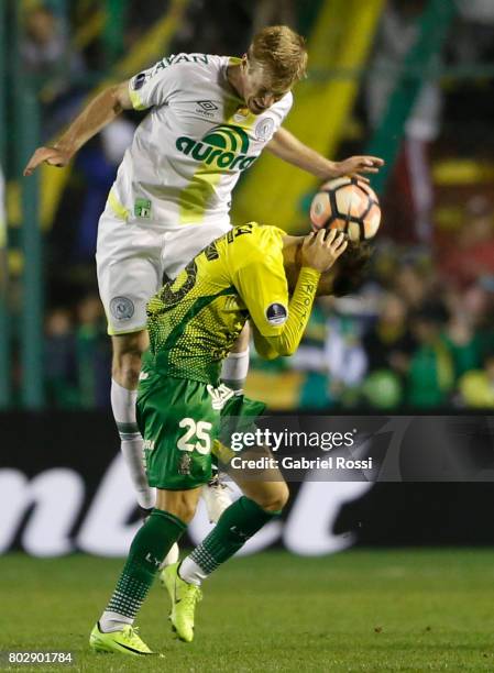 Douglas Grolli of Chapecoense heads the ball with Agustin Bouzat of Defensa y Justicia during a first leg match between Defensa y Justicia and...