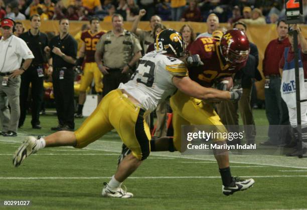Iowa defensive lineman Matt Kroul tackles Minnesota running back Jay Thomas during the Minnesota Gophers 34-24 victory over the Iowa Hawkeyes at the...