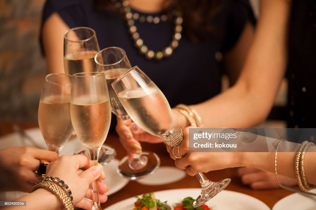 Close-up of the hands of the girls making a toast.