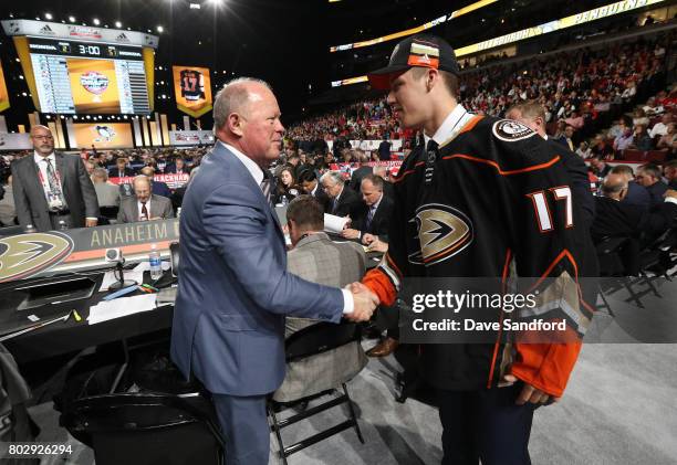 Maxime Comtois is greeted by general manager Bob Murray of the Anaheim Ducks after being selected 50th overall by the Anaheim Ducks during the 2017...