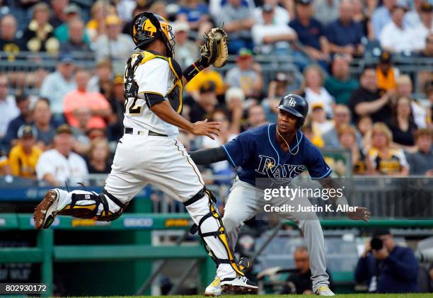 Elias Diaz of the Pittsburgh Pirates tags out Tim Beckham of the Tampa Bay Rays in the second inning during inter-league play at PNC Park on June 28,...