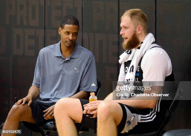 Charlotte Hornets assistant coach Stephen Silas, left, talks with Przemek Karnowski after practice at the Spectrum Center in Charlotte, N.C., on...