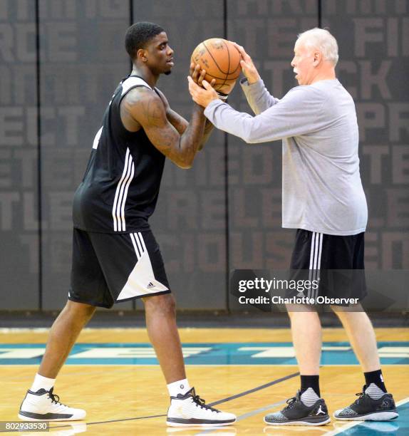 The Charlotte Hornets' Dwayne Bacon, left, gets extra instruction from assistant coach Bruce Kreutzer after practice at the Spectrum Center in...