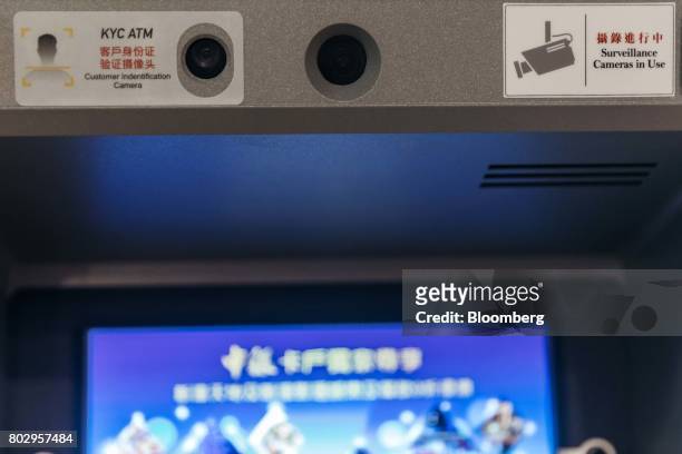 Customer identification camera, top left, sits on an automated teller machine equipped with facial-recognition software at a bank branch in Macau,...