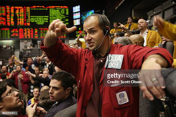 Daniel Adams signals offers in the Eurodollar futures pit at the Chicago Mercantile Exchange following the announcement from the Federal Open Market...