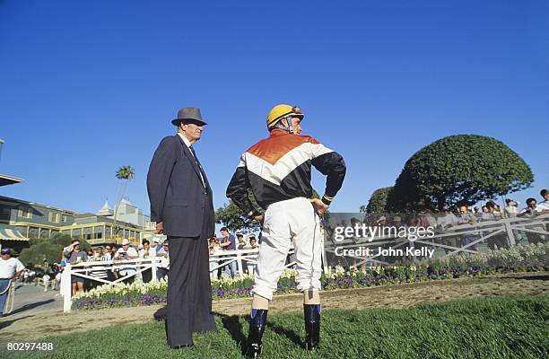 Hall of fame trainer Charlie Whittingham and hall of fame jockey Gary Stevens discuss pre-race strategey in the paddock at Santa Anita Park.