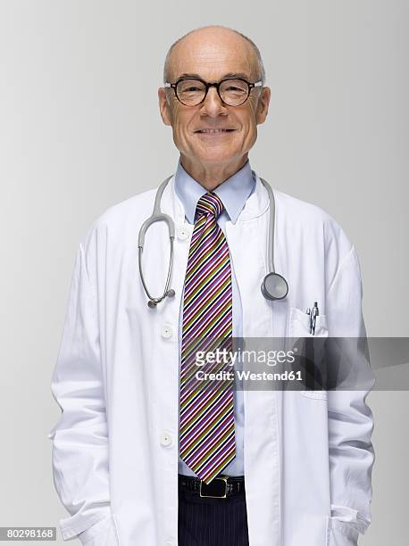 senior male doctor, portrait - stethoscope white background stock pictures, royalty-free photos & images