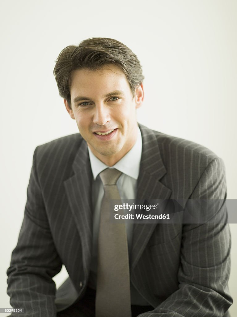 Young businessman smiling, portrait