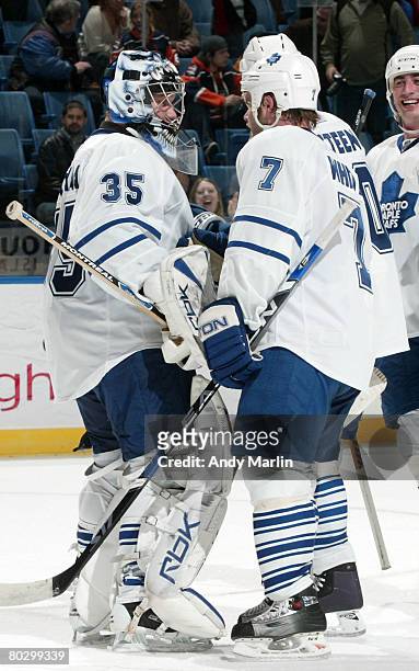 Winning goaltender Vesa Toskala of the Toronto Maple Leafs is congratulated by Ian White after defeating the New York Islanders at the Nassau...