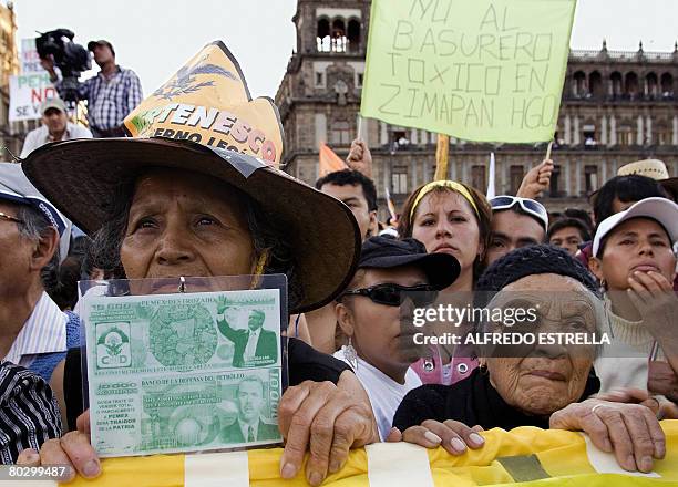 Supporters of Mexican former presidential candidate Andres Manuel Lopez Obrador listen during a rally against the privatization of state-owned oil...