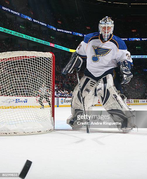 Manny Legace of the St. Louis Blues keeps an eye on a loose puck against the Montreal Canadiens at the Bell Centre on March 18, 2008 in Montreal,...