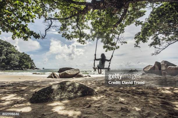 woman on a swing on the beach - khao lak stock pictures, royalty-free photos & images