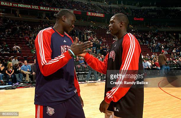 DeSagana Diop of the New Jersey Nets greets Luol Deng of the Chicago Bulls prior to the start of the NBA game on March 18, 2008 at the United Center,...