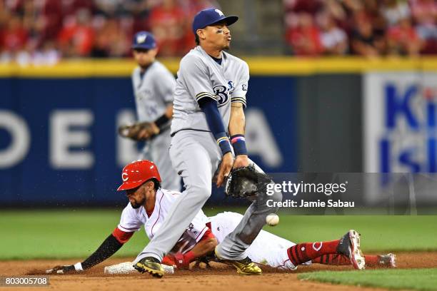 Billy Hamilton of the Cincinnati Reds steals second base in the eighth inning as Orlando Arcia of the Milwaukee Brewers bobbles the throw at Great...