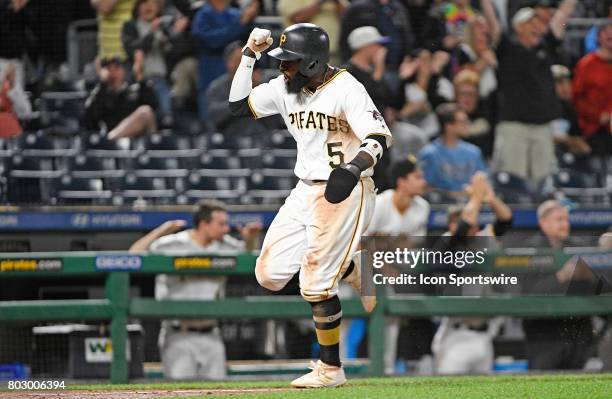 Pittsburgh Pirates second baseman Josh Harrison reacts as he comes around to score on a two run RBI double by Pittsburgh Pirates center fielder...