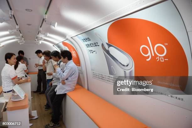 Customers try out British American Tobacco Plc's Glo smokeless tobacco devices in Tokyo, Japan, on Monday, June 26, 2017. By next week, smokeless...