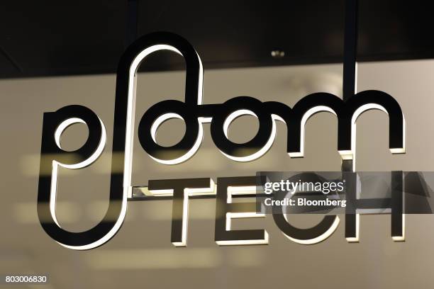 The logo for Japan Tobacco Inc.'s Ploom Tech smokeless tobacco devices is displayed at the company's Ploom Shop Ginza in Tokyo, Japan, on Wednesday,...