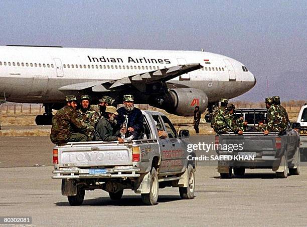 In this picture taken December 27 Afghan Taliban militia head towards a hijacked Indian Airlines Airbus AC-814 at Kandahar Airport. India has accused...