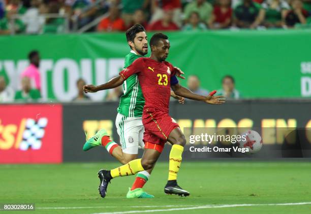 Rodolfo Pizarro of Mexico vies for the ball with Harrison Afful of Ghana during the friendly match between Mexico and Ghana at NRG Stadium on June...