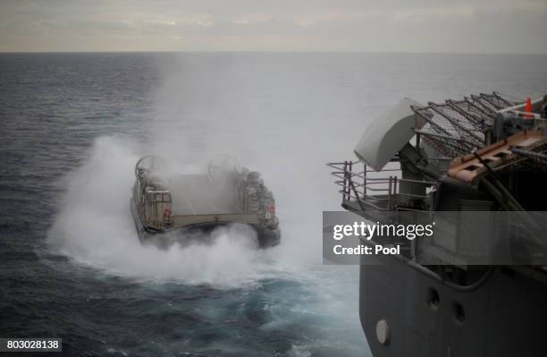 Navy Landing Craft Air Cushion appears from the stern of the USS Bonhomme Richard amphibious assault ship during events marking the start of Talisman...