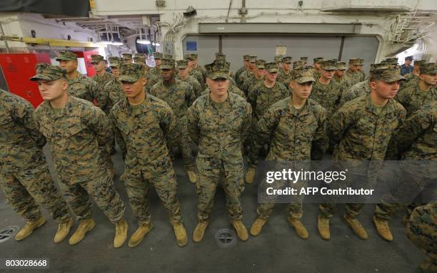 Marines stand aboard the USS Bonhomme Richard amphibious assault ship during a ceremony marking the start of Talisman Saber 2017, a biennial joint...