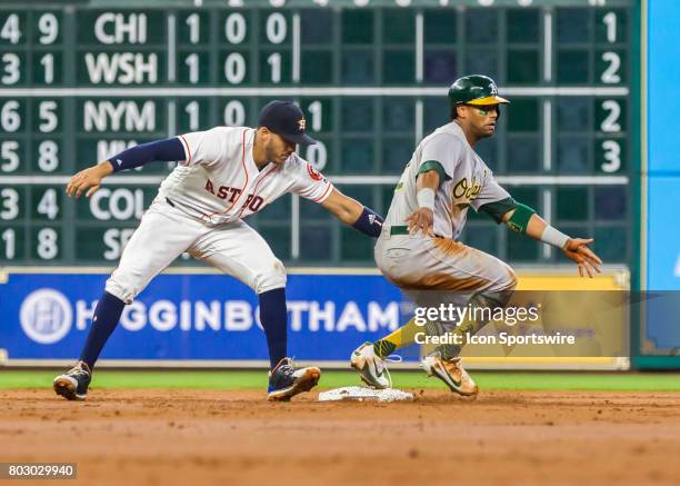 Houston Astros shortstop Carlos Correa tags Oakland Athletics designated hitter Khris Davis during the MLB game between the Oakland Athletics and...