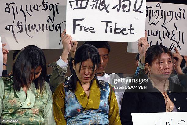 Tibetans shade tears during a rally to demand independence as Taiwan's ruling Democtaric Party presidential candidate Frank Hsieh attending an...