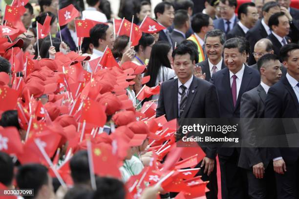 Xi Jinping, China's president, third right, and Leung Chun-ying, Hong Kong's chief executive, forth right, greet attendees after Xi arrived at Hong...