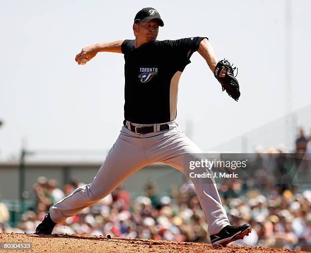 Starting pitcher A.J. Burnett of the Toronto Blue Jays makes a pitch against the Pittsburgh Pirates during the Grapefruit League Spring Training game...