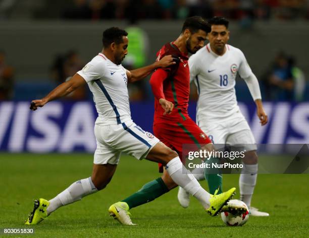 Andre Gomes of Portugal national team vies for the ball with Jean Beausejour of Chile national team and Gonzalo Jara of Chile national team during...