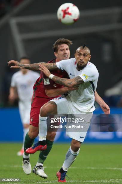 Bruno Alves of the Portugal national football team and Arturo Vidal of the Chile national football team vie for the ball during the 2017 FIFA...