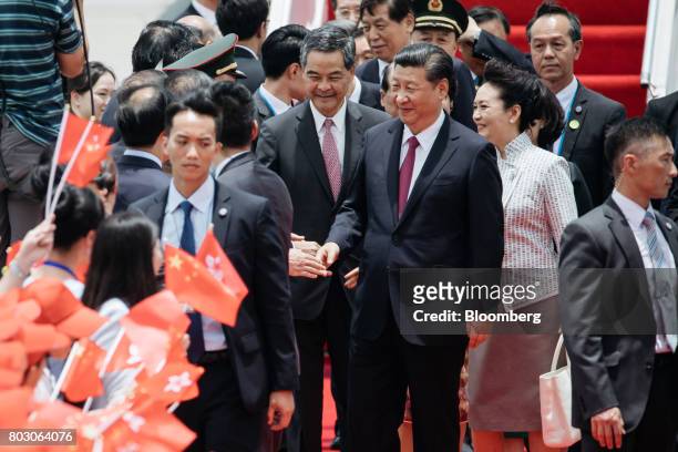 Xi Jinping, China's president, center right, Peng Liyuan, China's first lady, second right, greet attendees with Leung Chun-ying, Hong Kong's...